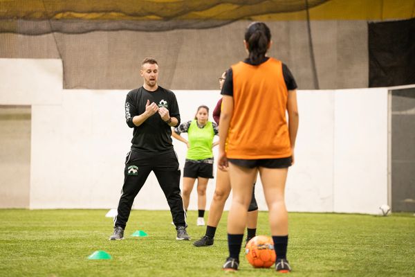 Soccer Coach instructing soccer players during a drill