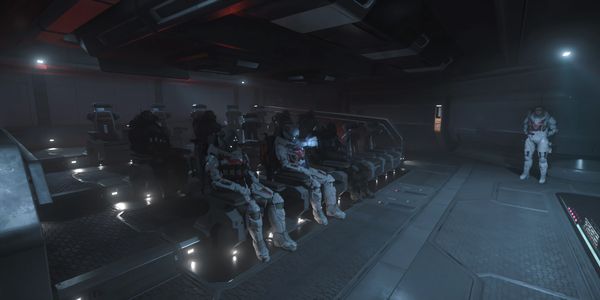 Futuristic soldiers in armored suits seated in a spaceship cabin.