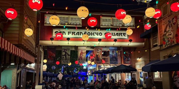 Night scene at San Fransokyo Square with hanging lanterns and people dining outdoors.