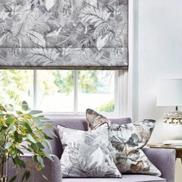 Roman blind behind sofa with cushions in silver/ grey