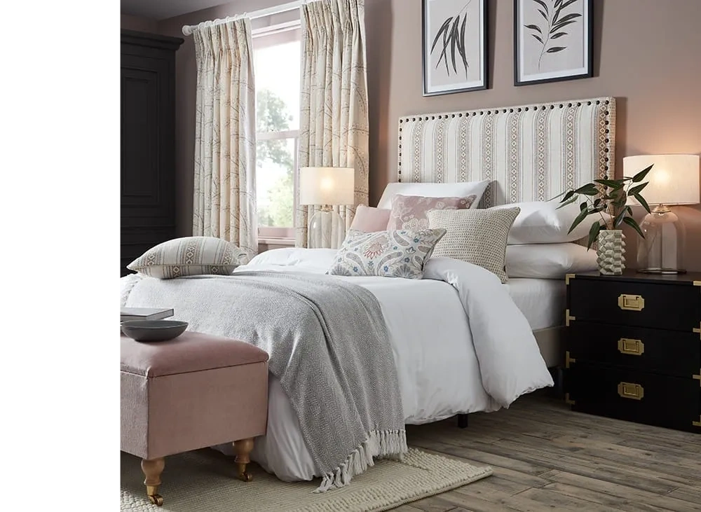 interior design image upholstered headboard and wite bed linen