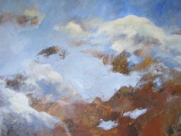 A sky filled with soft, textured clouds against a blue backdrop.