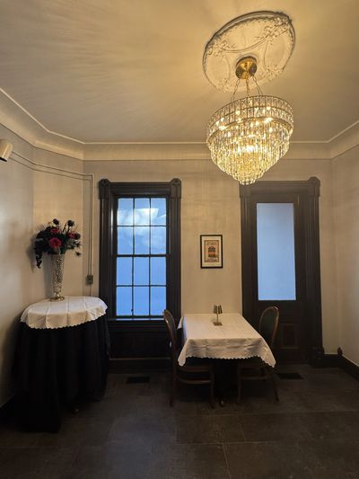 Elegant dining area with crystal chandelier and classic decor.