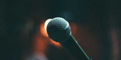 Close-up of a microphone with a blurred background.