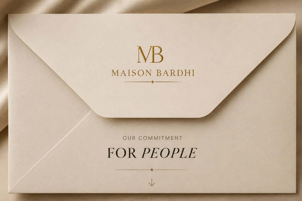 Elegant beige envelope with gold and black lettering.
