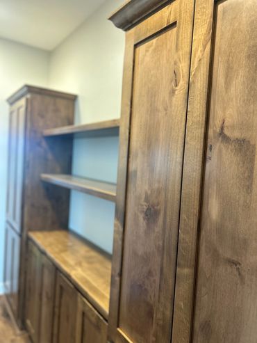 Knotty alder hallway cabinets with trophy shelves