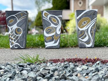 Nuu-chah-nulth designs on planters - raven, wolf and whale to represent air, land and sea.