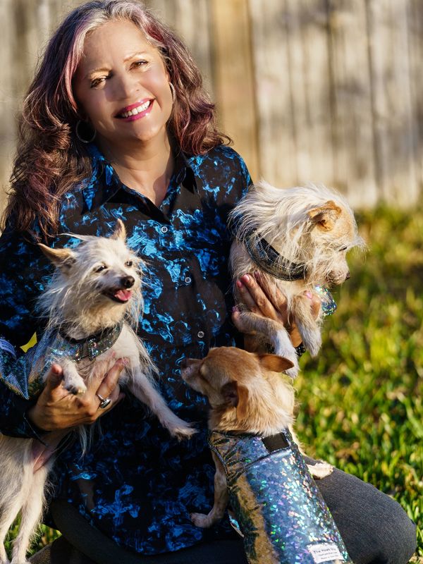certified pet nutritionist woman with 3 dogs in hawk star vests