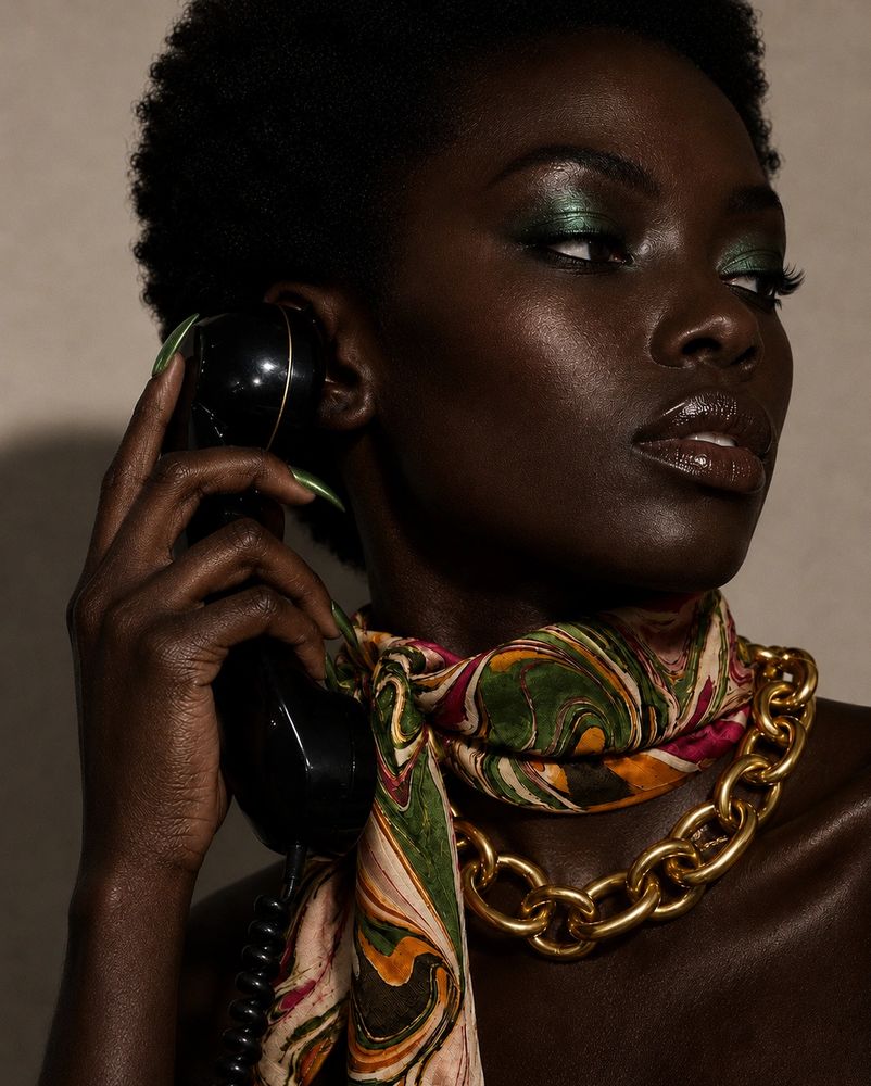 Editorial portrait of a model holding a vintage rotary phone, wearing the Green With Envy silk scarf