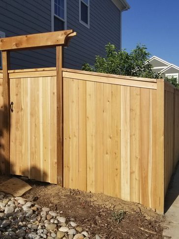 New cedar wood fence with arbor