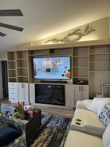 Modern living room with a TV, fireplace, and cozy seating area.