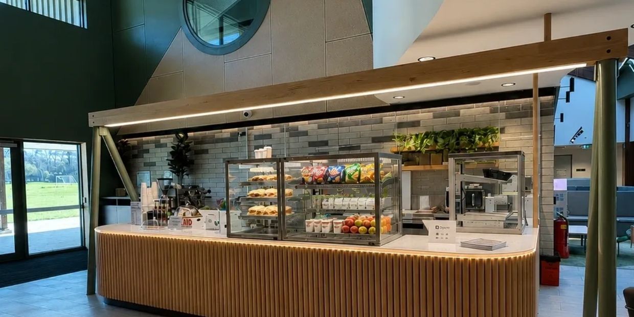 Modern snack bar with pastries, chips, and fresh fruit.