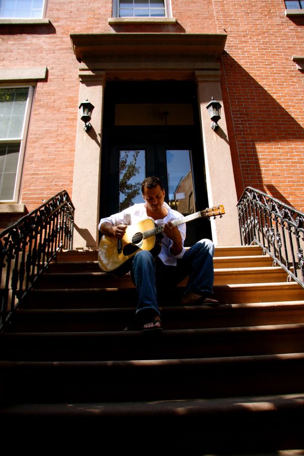 Derek Samuel Reese playing his guitar