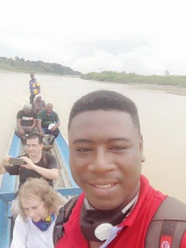 Group of people enjoying a boat ride on a river.
