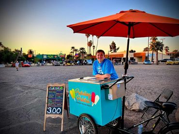The Pedaling Paletas tricycle at an event in the Casa Grande Mainstreet Neon Sign Park.
