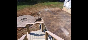 outdoor firepit and steps toward stained concrete