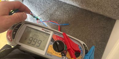 Digital multimeter measuring electrical resistance.