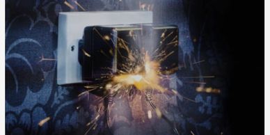 Electrical sparks coming from a wall socket.