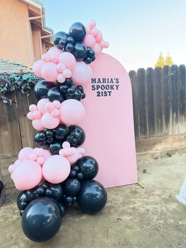 Pink and black balloon arch for Maria's spooky 21st birthday.