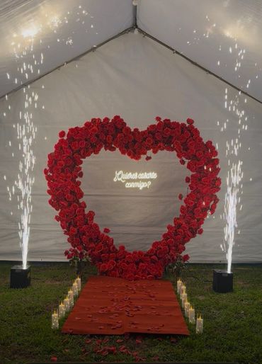 Heart-shaped rose arrangement with proposal message and sparklers.