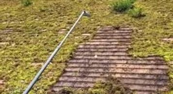 exterior cleaning business showing scraping moss from roof tiles in Alsager