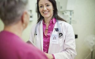 A Woman doctor with patient discuss each other