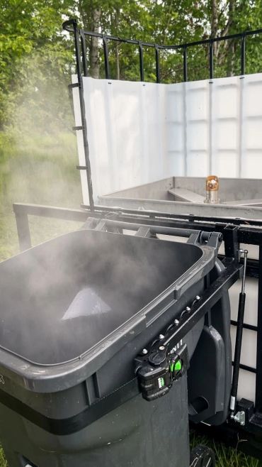 A steaming trash bin after being freshly cleaned
