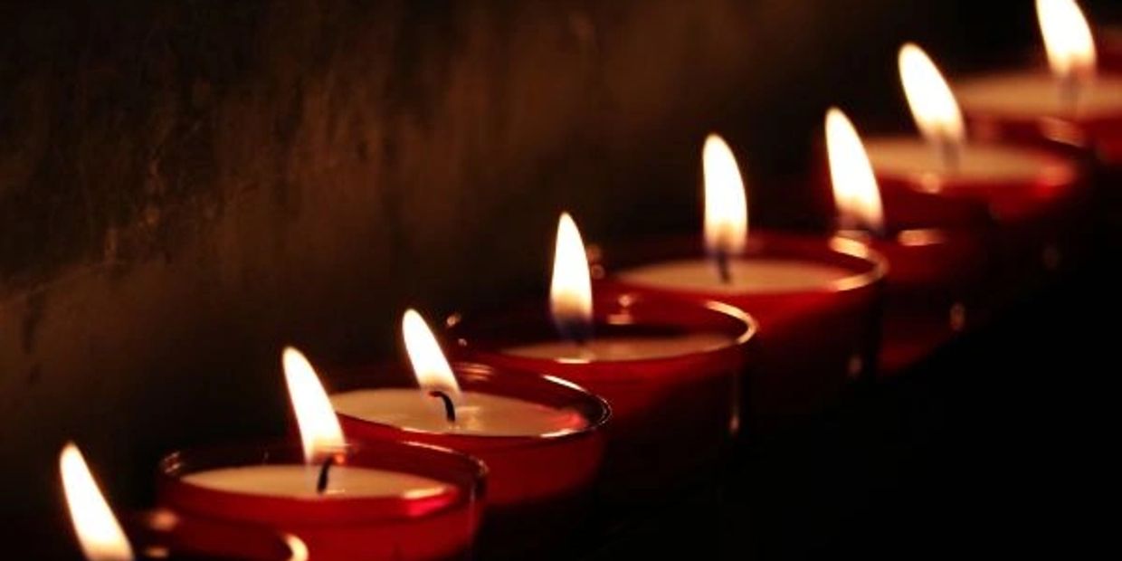 Row of lit candles creating a warm, peaceful ambiance.