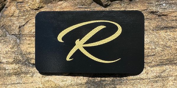 Photo of the metal black and gold R Card.