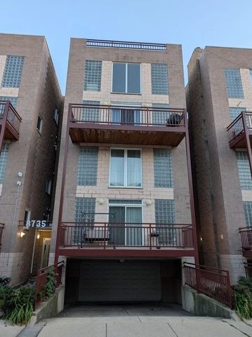 Three-story townhouse with balconies and garage.