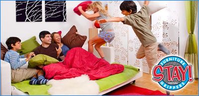 People jumping on a couch while our non slip furniture pads prevent the sofa from sliding.