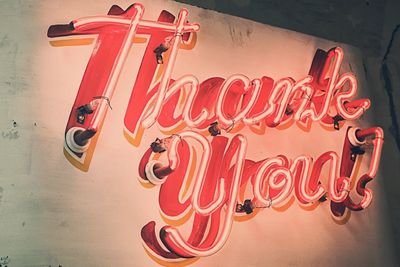 Neon sign displaying "Thank You!" in bright red and pink colors.