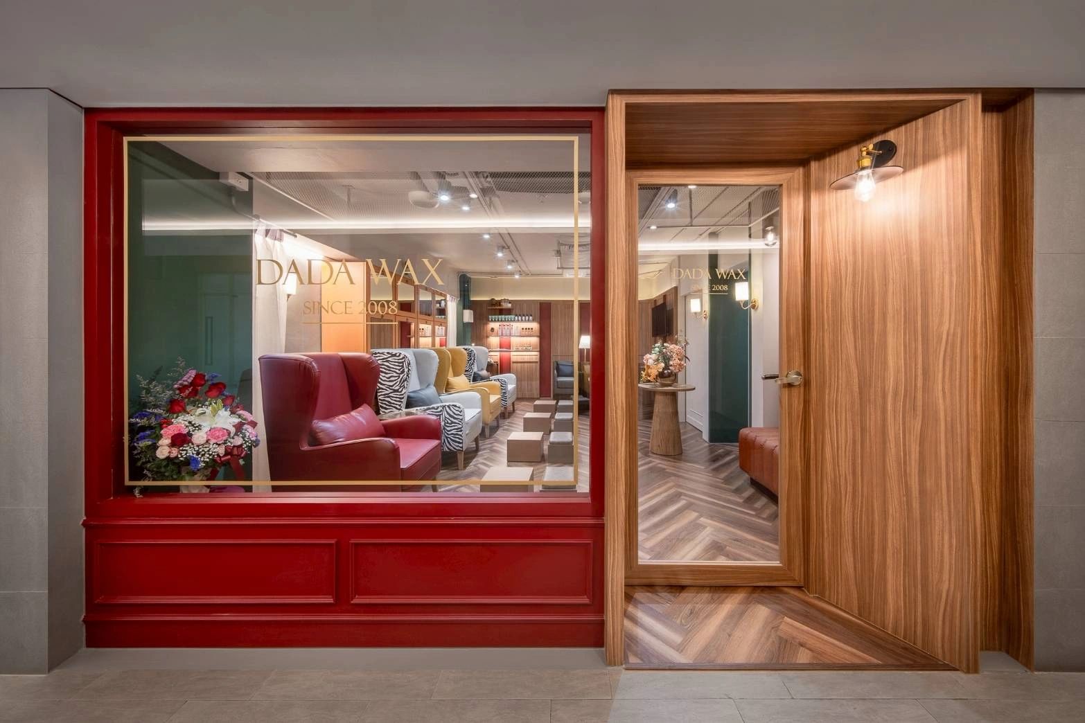 Stylish salon interior with colorful chairs and wooden accents at DADA WAX.