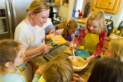 White Female Cooking instructor teaching young female students