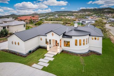 Aerial view of a custom home and landscaped grounds