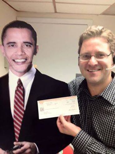 Person holding a cheque