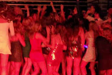 DJ lights shine on a crowd as NW Wedding DJs work as their Event DJ.