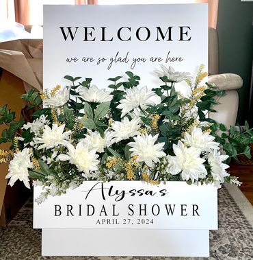 Flower box welcome easel to greet guests. Customize with your own event colors.