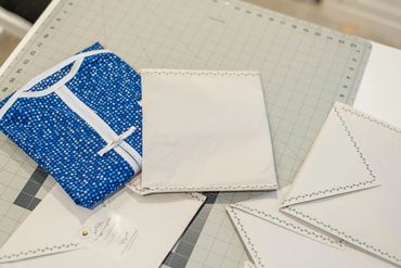 Garment cover folded and being put into mailer.