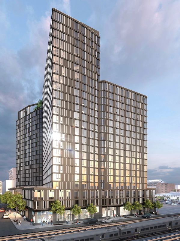 Modern high-rise building reflecting sunlight in an urban setting.