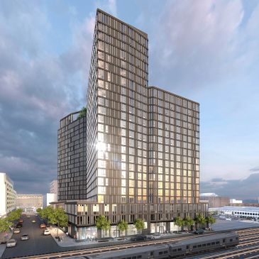 Modern high-rise building with reflective glass windows at sunset.