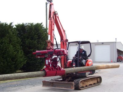 The EZ-HD08 Heavy Duty Pole Setter on an excavator with a pole.