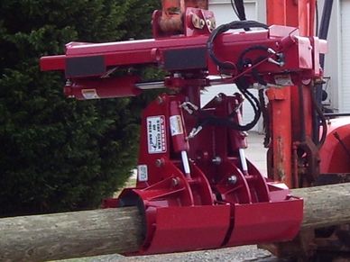 The EZ Spot UR EZ-HD08 Heavy Duty Pole Setter on an excavator moving a large utility pole.