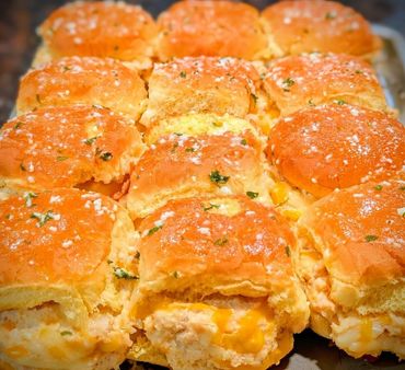 Golden baked sliders topped with herbs and coarse salt.