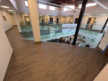 Commercial flooring installation with wood-look LVP/LVT for offices and high-traffic spaces.
