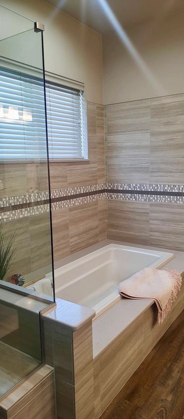 Modern bathroom with a built-in bathtub and glass shower enclosure.
