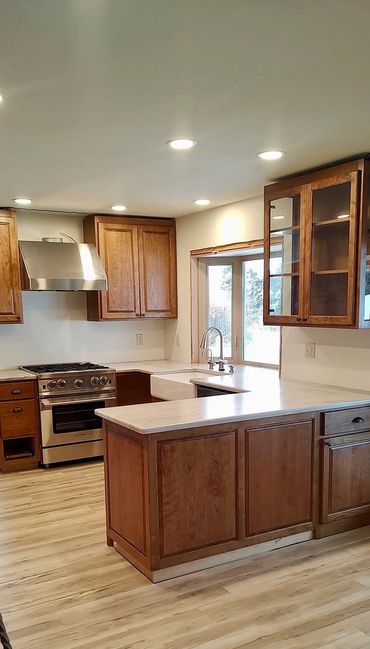 Modern kitchen with wooden cabinets and stainless steel appliances.