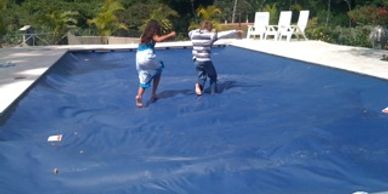 kids playing on pool cover