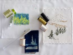 Conifers in three media, by Katherine Colwell, and embroidery plan options, thread spools, beads.