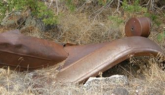 Rusty vehicle parts, old homestead remains at Colwell Cedars Retreat.